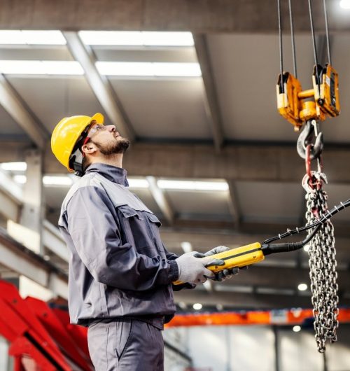 Worker operating electric chain hoist